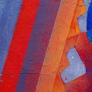 Close-up of a colorful abstract street art mural with vivid geometric patterns and textures.